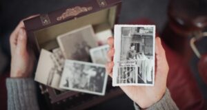 Old family photographs and documents kept in a memory box, representing historic Irish records